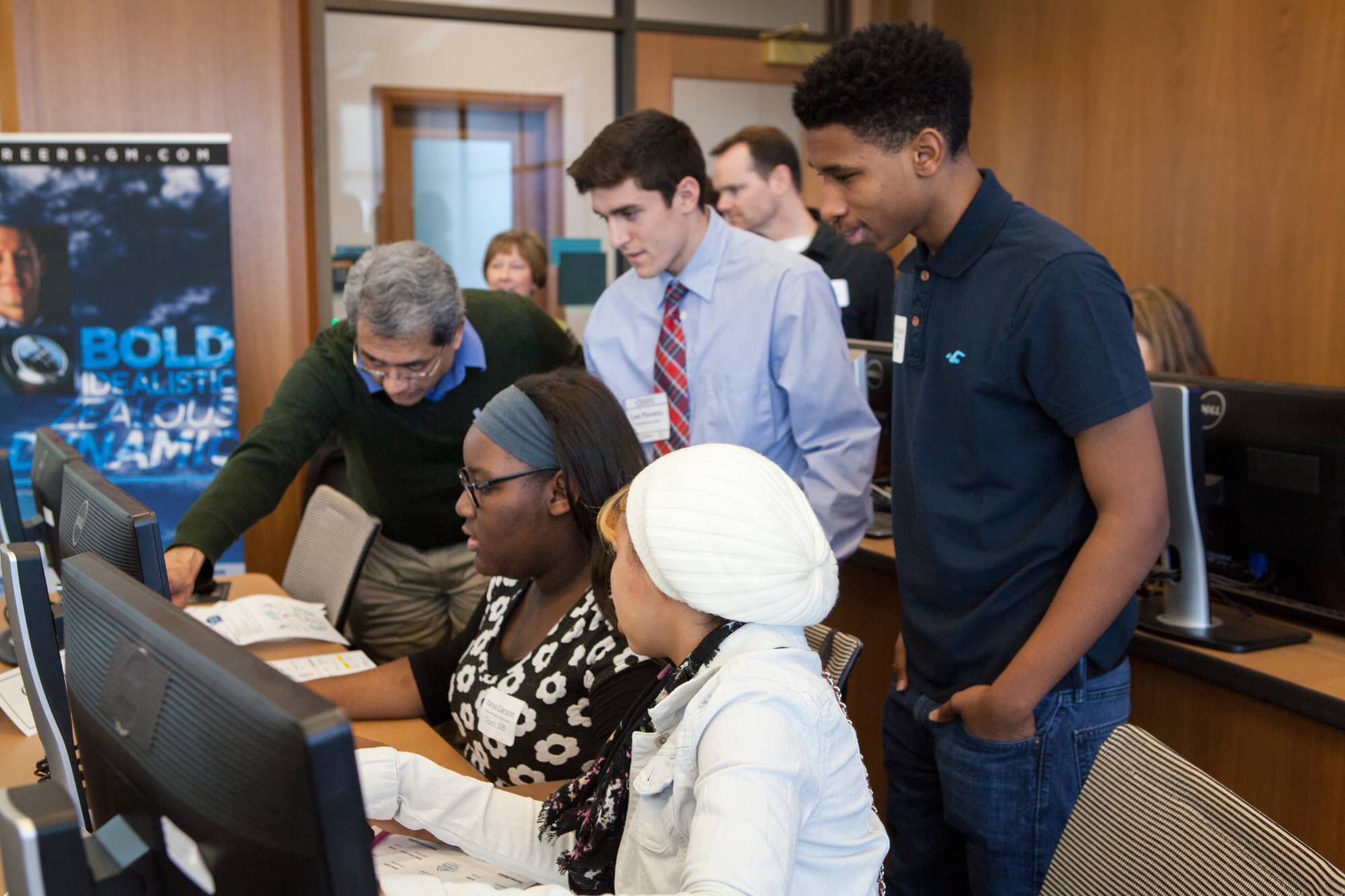 Students working in a computer lab with a GVSU faculty member